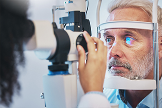 Ophthalmology, medical and eye exam with old man and consulting for vision, healthcare and glaucoma check.